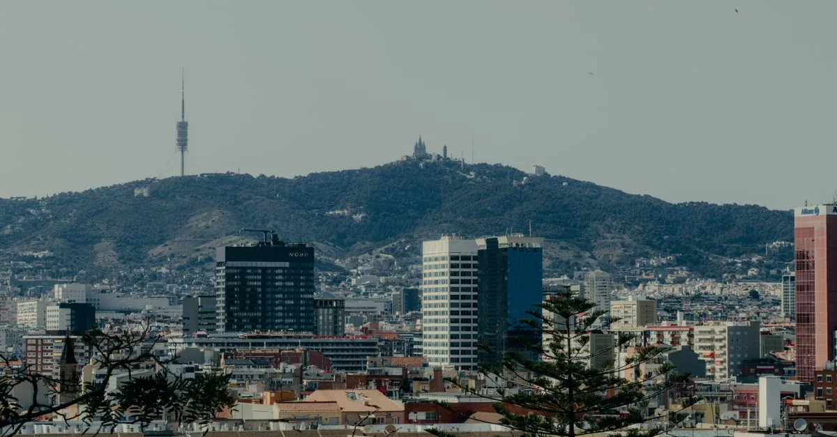 Scenic view of Barcelona skyline featuring Tibidabo Mountain and Collserola Tower.