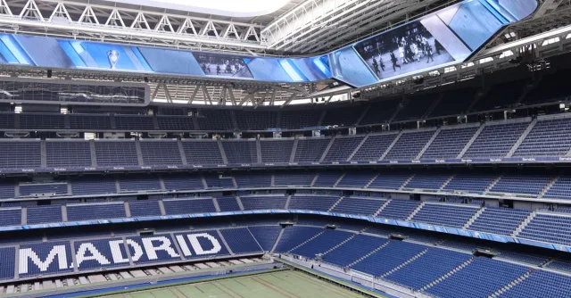 Explore the modern architecture of Santiago Bernabéu Stadium in Madrid, Spain, with its iconic branding.