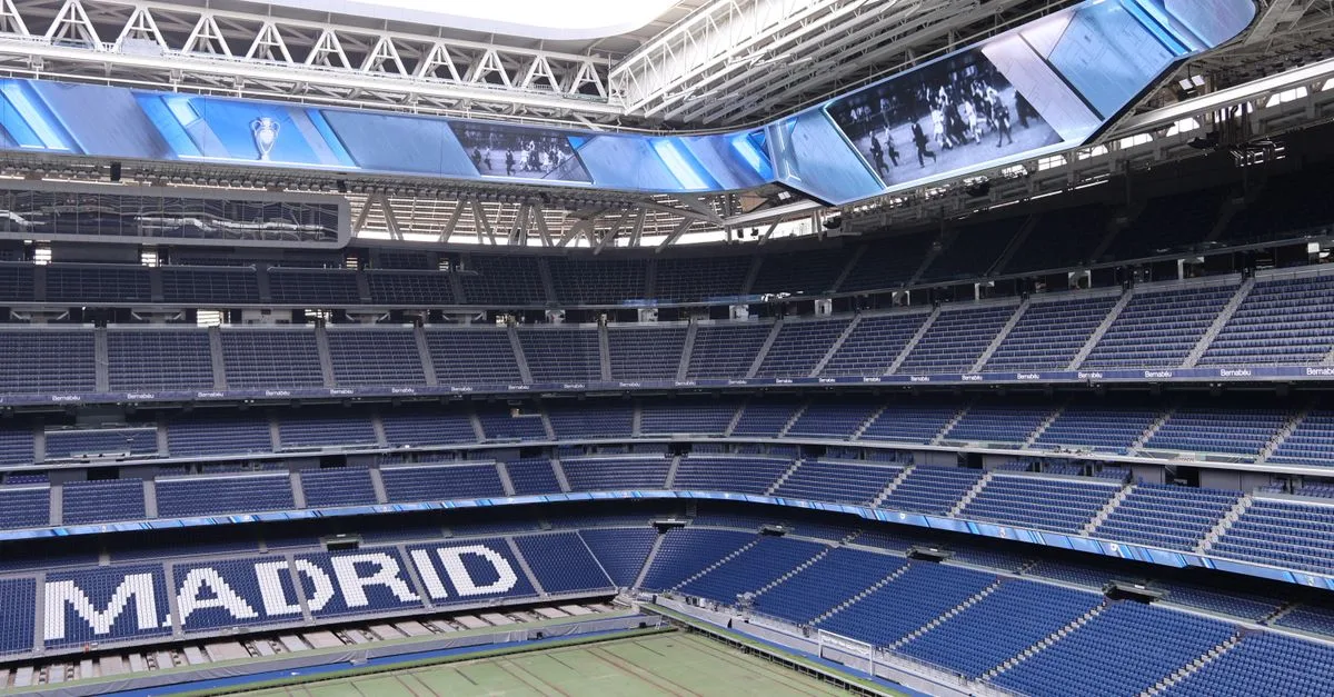 Explore the modern architecture of Santiago Bernabéu Stadium in Madrid, Spain, with its iconic branding.