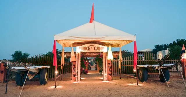 Scenic entrance of Prince Desert Camp with traditional carts in Jaisalmer, India during twilight.