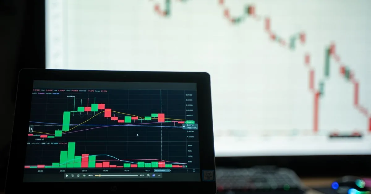 Close-up of a laptop showing cryptocurrency market charts in a trading environment.