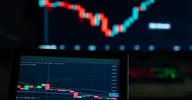 Detailed view of cryptocurrency trading charts on digital screens, showcasing market fluctuations.