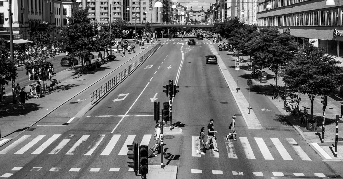 View of a busy Stockholm street crossing in black and white, summer.
