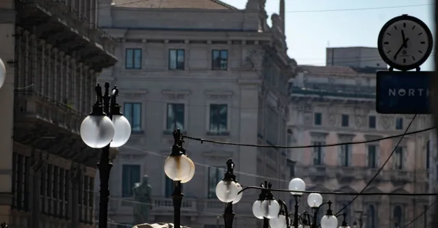 Historic architecture in Milan with decorative lamp posts lining elegant streets.