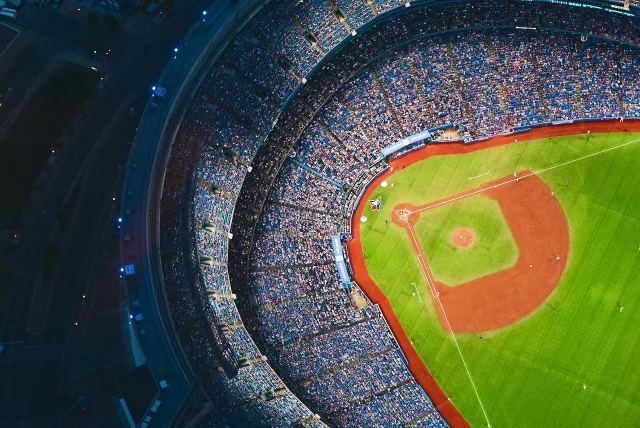 A professional baseball stadium field during a game under stadium lights.