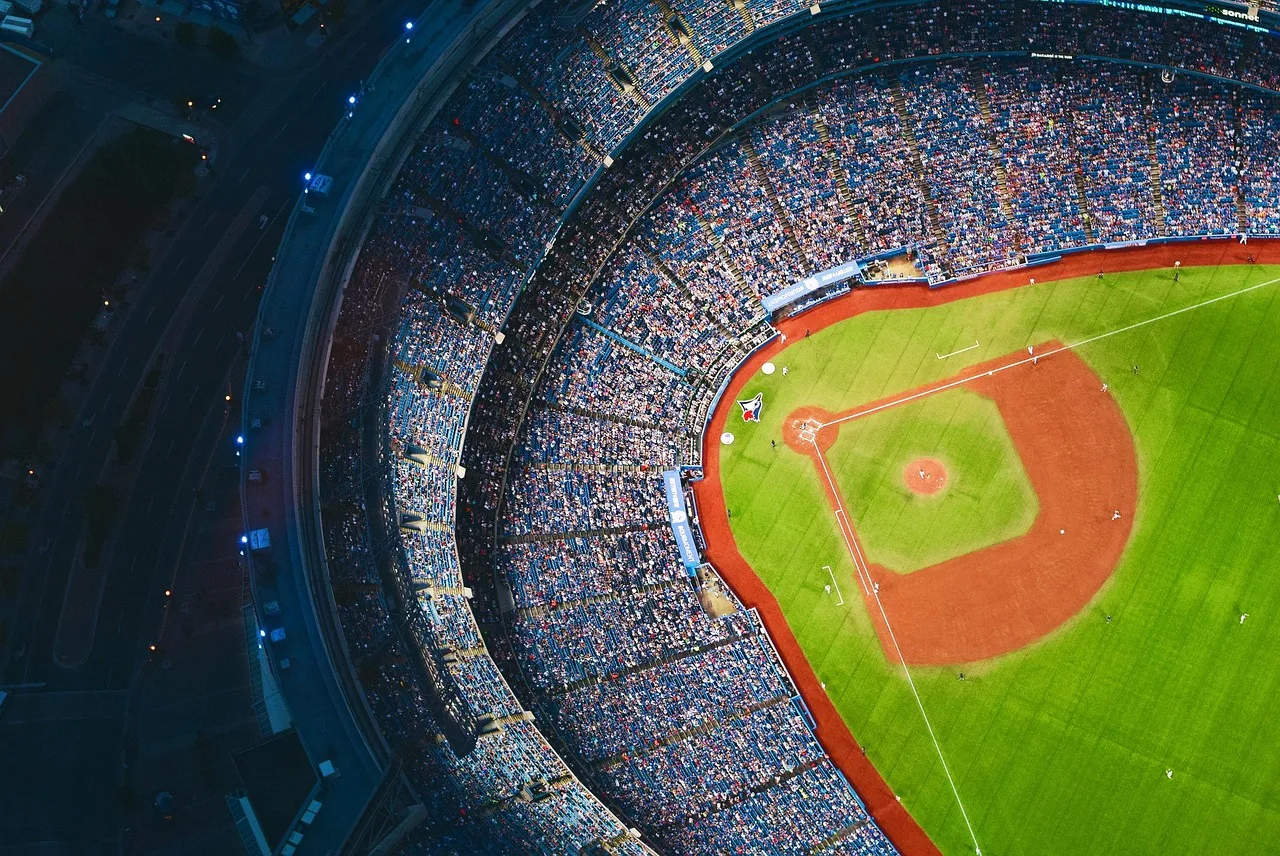 A professional baseball stadium field during a game under stadium lights.