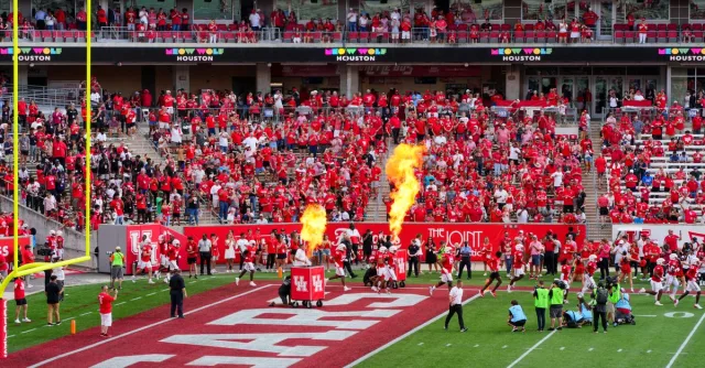 Houston college football match with vibrant crowd and fire effects. Captures the sports spirit.
