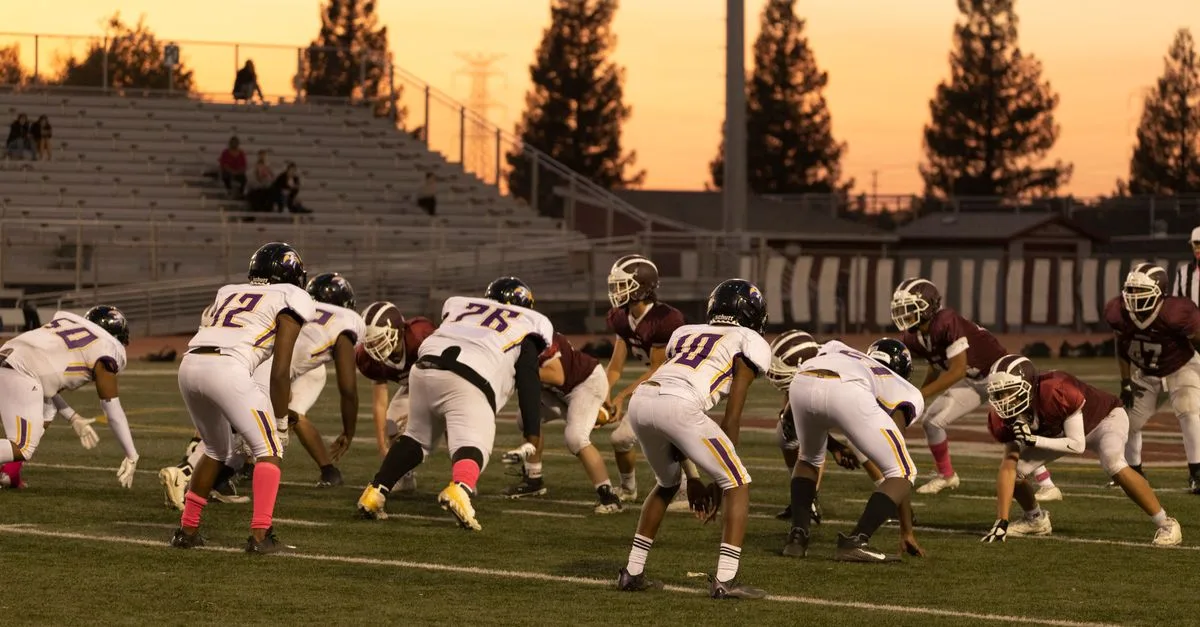 Intense American football game between two teams at sunset in Roseville, California.