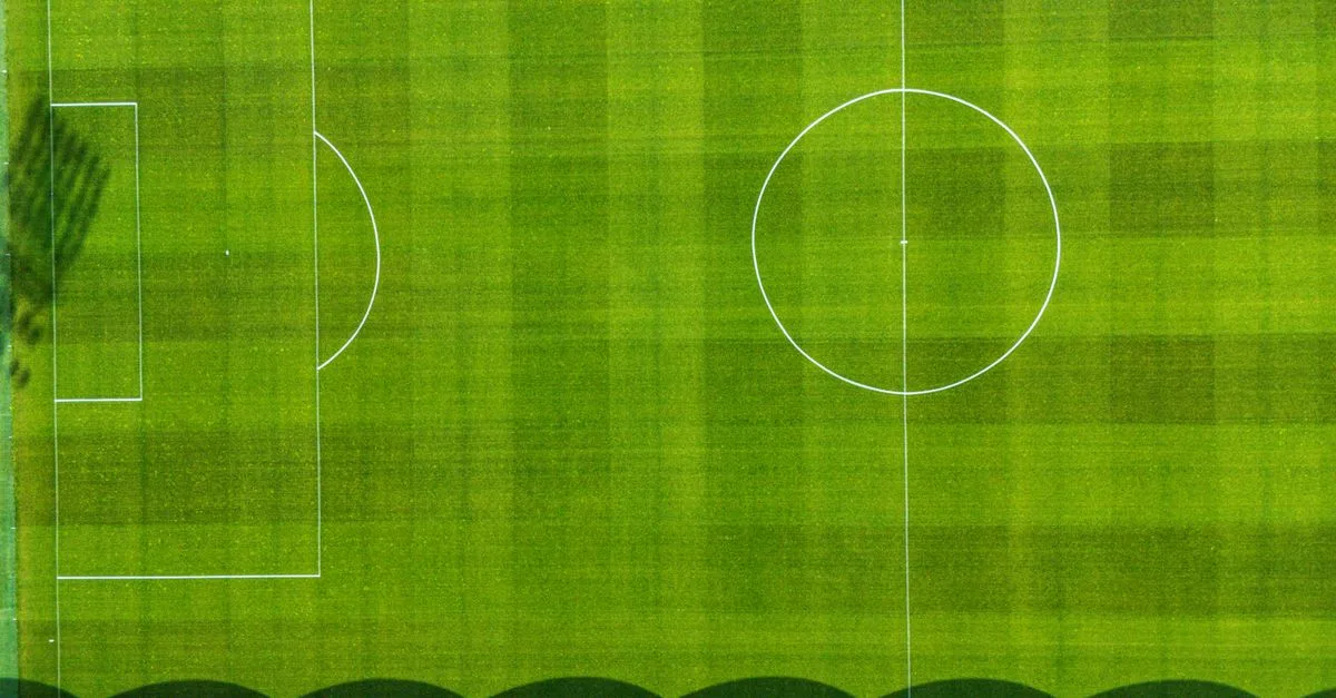 Drone view of a green football field in Jönköping, Sweden, showcasing the pitch from above.