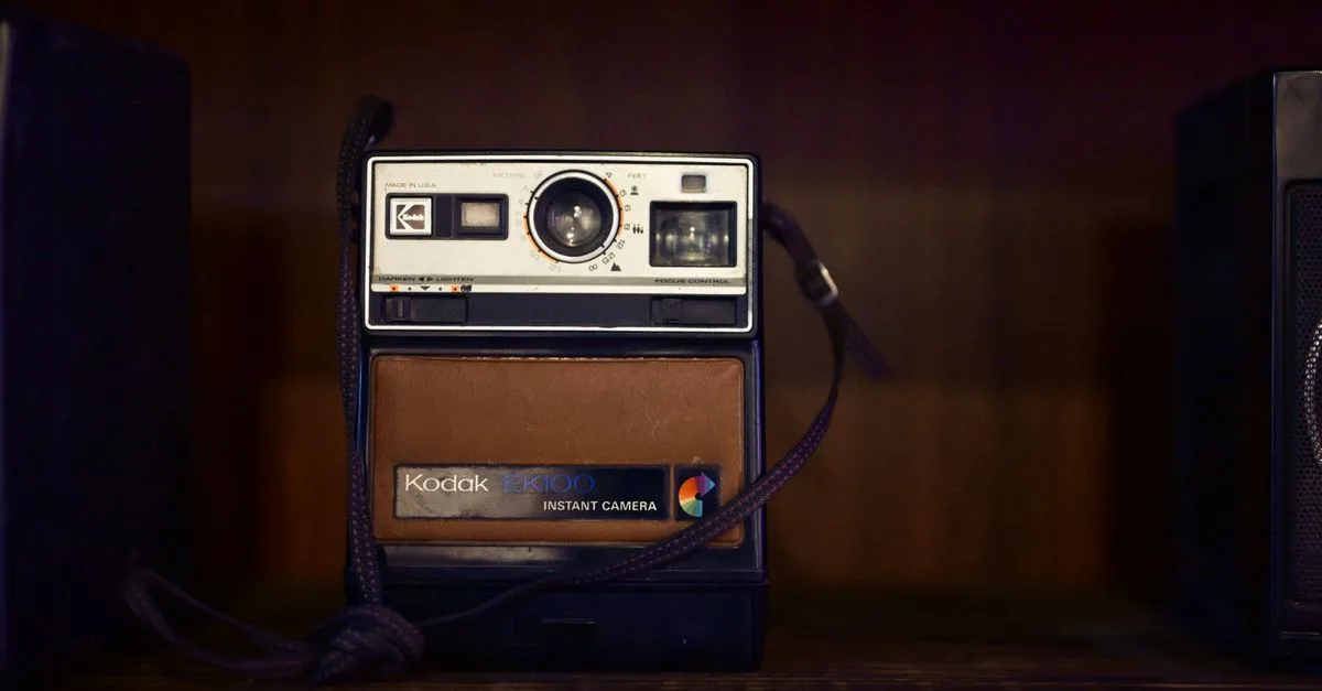 A classic Kodak EK100 instant camera in a vintage setting, evoking nostalgia.