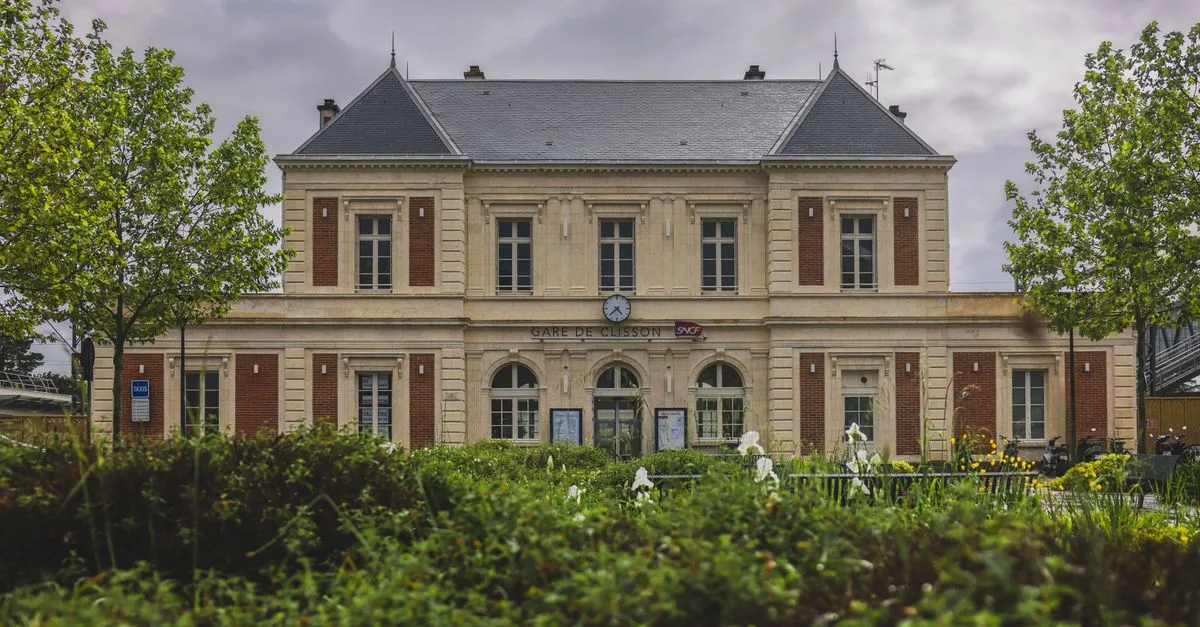 Clisson train station in France, showcasing classic architecture amidst scenic spring foliage.