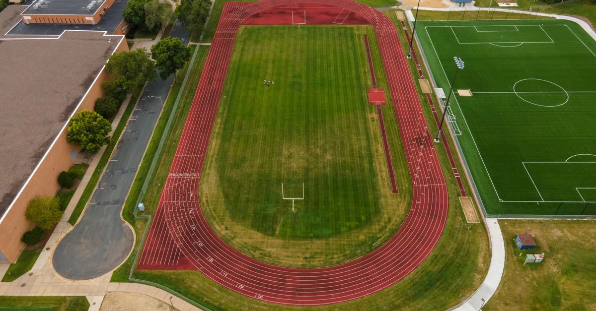 Aerial view of track and soccer field in Menomonie, WI, showcasing sports facilities from above.