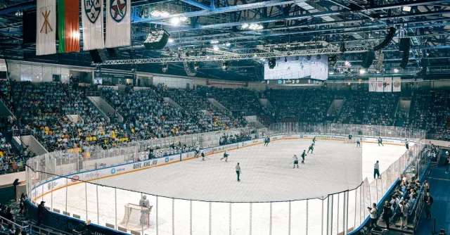 Exciting ice hockey game with players and crowd in a vibrant indoor arena atmosphere.