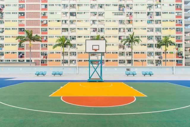 An empty professional basketball court under bright arena lights.
