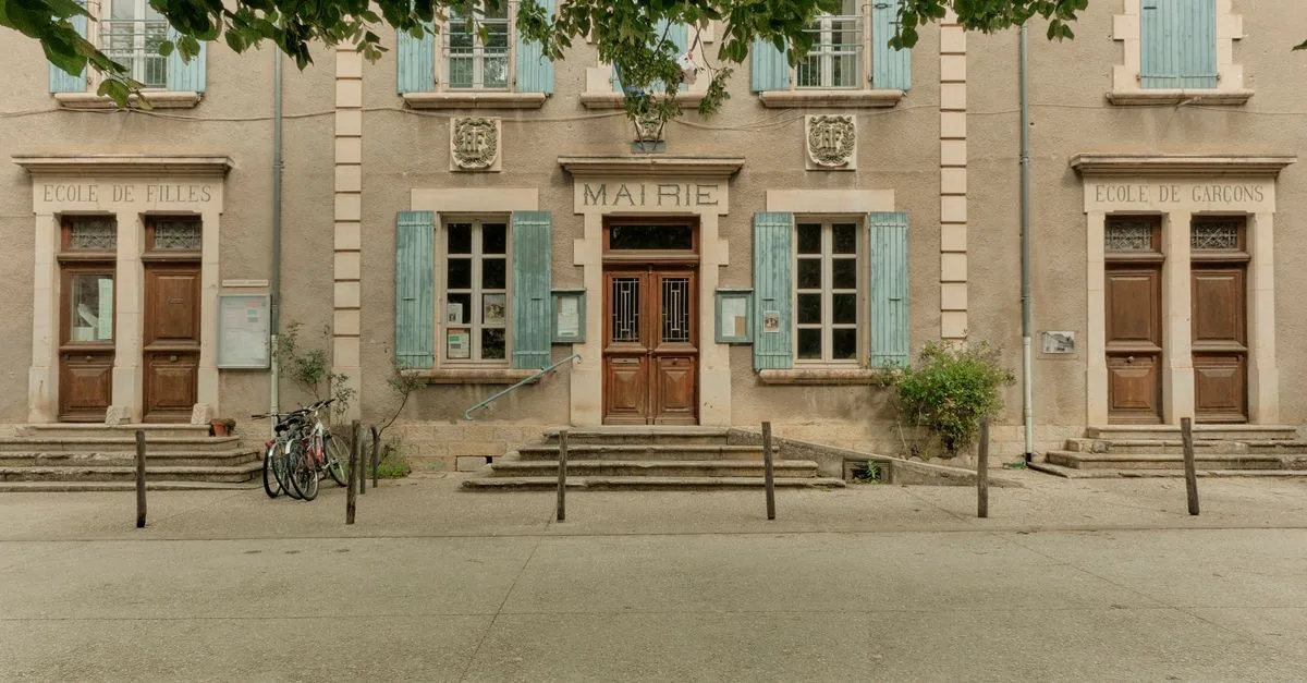 Front view of a traditional French town hall in Auvergne-Rhône-Alpes, France, during summer.