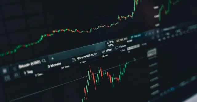 Close-up of a digital market analysis display showing Bitcoin and cryptocurrency price trends.