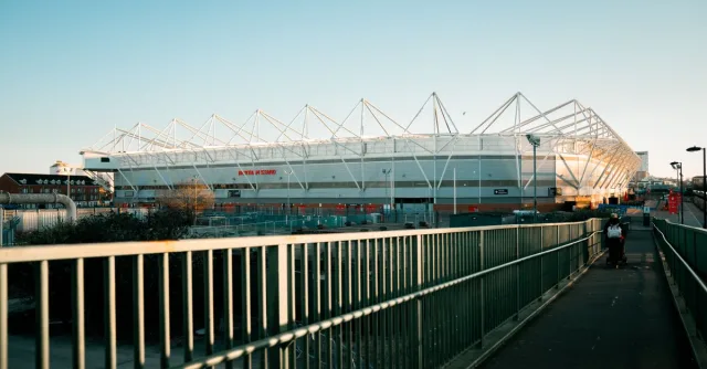 View of St Mary's Stadium in Southampton during sunset with a clear sky.