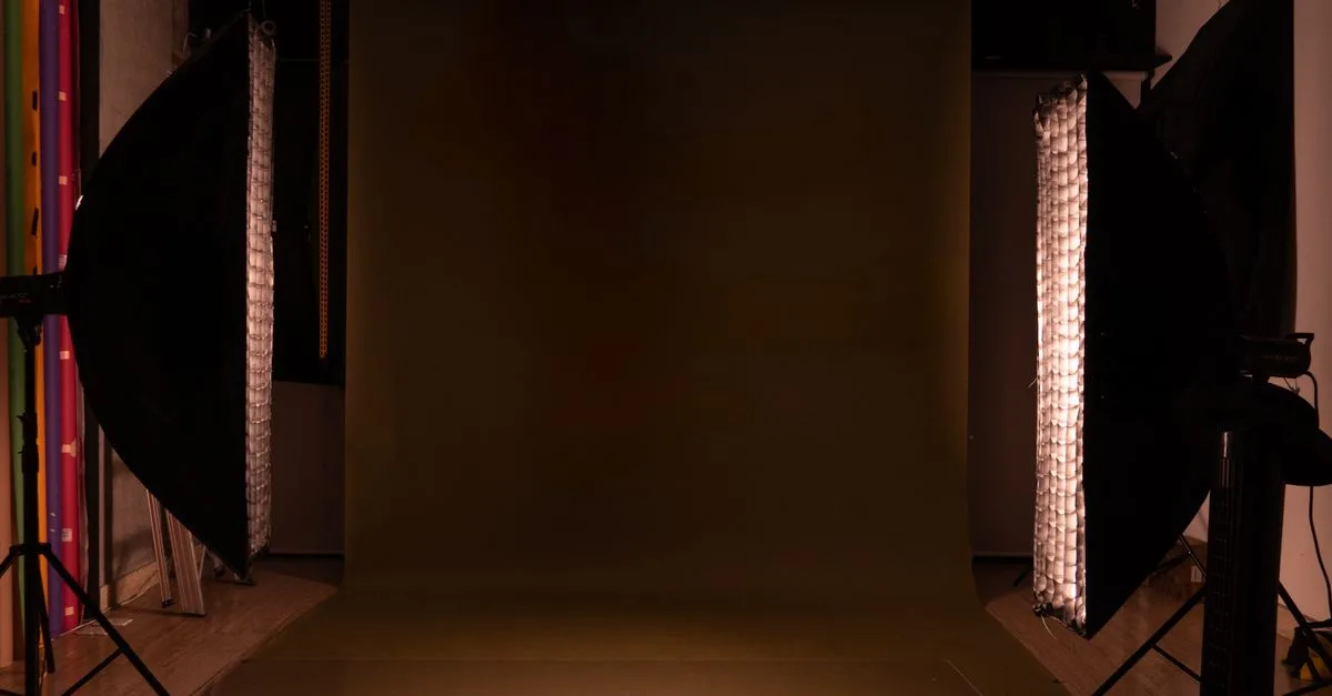 A sleek and modern photography studio setup featuring a mocha backdrop and professional lighting equipment.