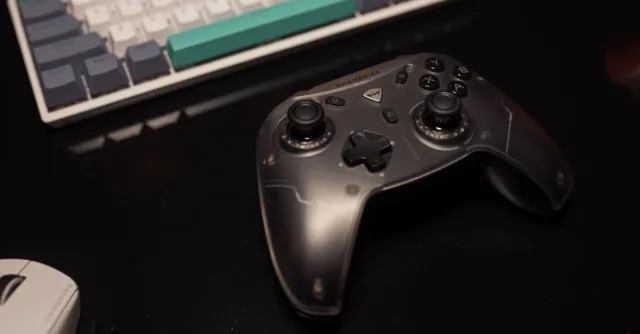 Close-up of a gaming controller on a desk with a keyboard and mouse, perfect for gamers.