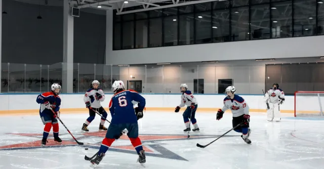 Dynamic ice hockey scene with players in an indoor rink ready for face-off. Captivating sports moment.
