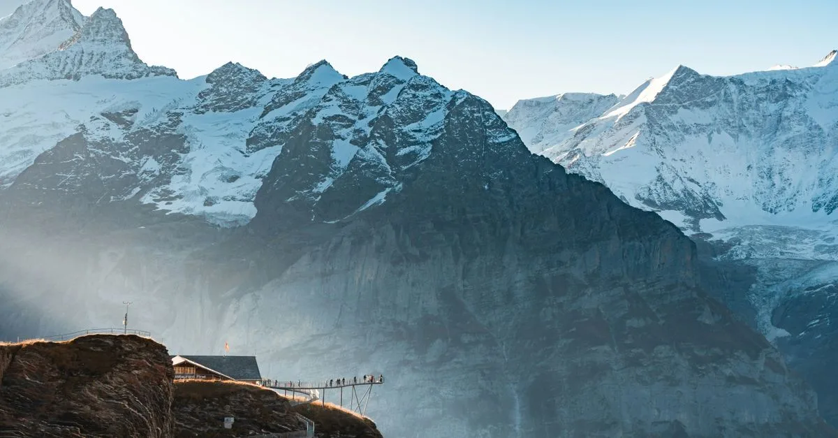 Explore the stunning snowcapped peaks and scenic walkways of the Swiss Alps at sunrise.