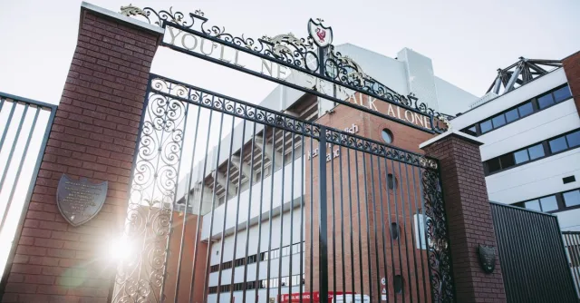 A photo capturing the iconic gates of Anfield Stadium, Liverpool, with sunrays illuminating the architecture.