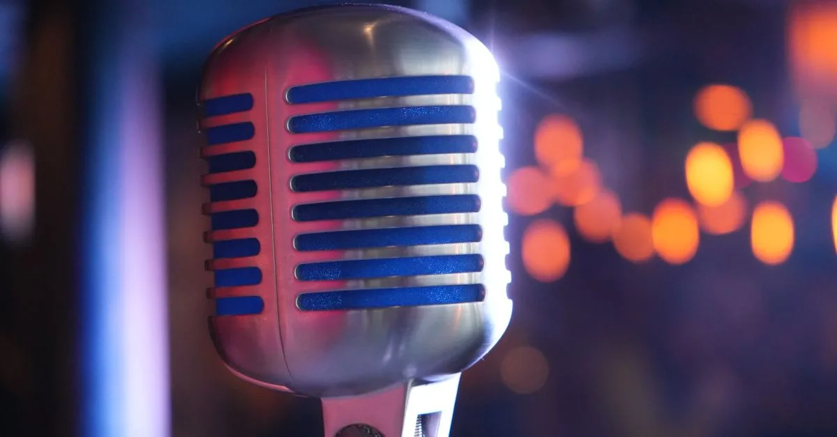 Close-up of a classic microphone with colorful bokeh, ideal for music and performance themes.