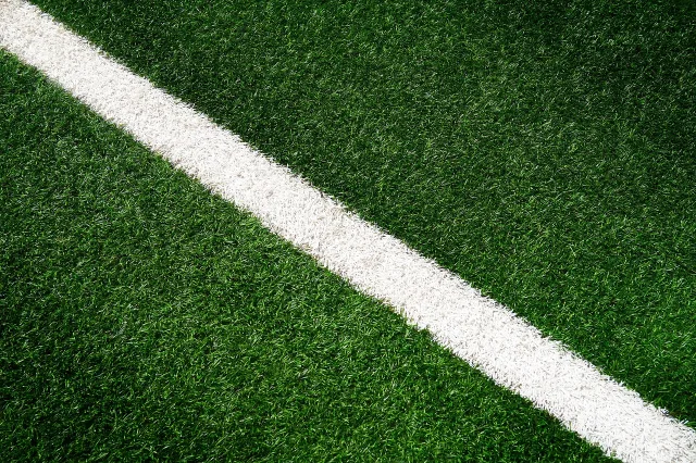 A professional football stadium pitch prepared for a match.