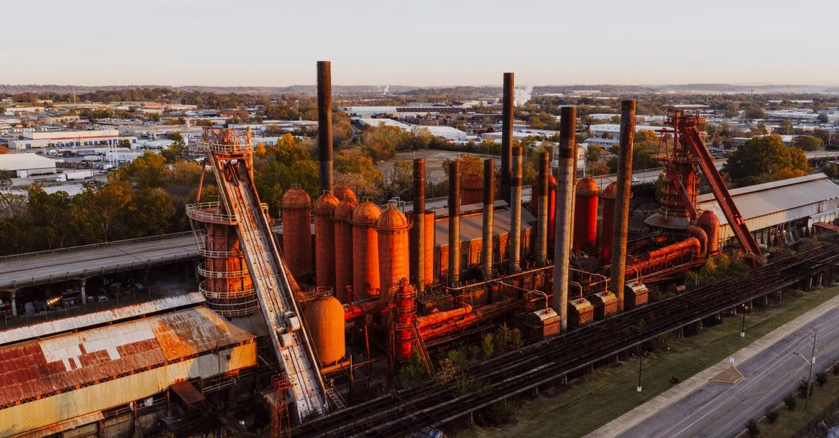 Aerial photograph showcasing the historic Sloss Furnaces in Birmingham, Alabama during sunset.