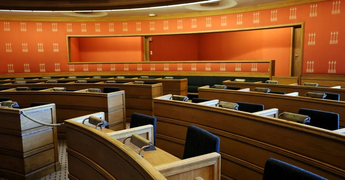 An empty parliamentary meeting room with wooden seating and vibrant orange walls in Oslo, Norway.