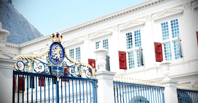 Stunning view of an ornate gate and historical building facade in daylight.