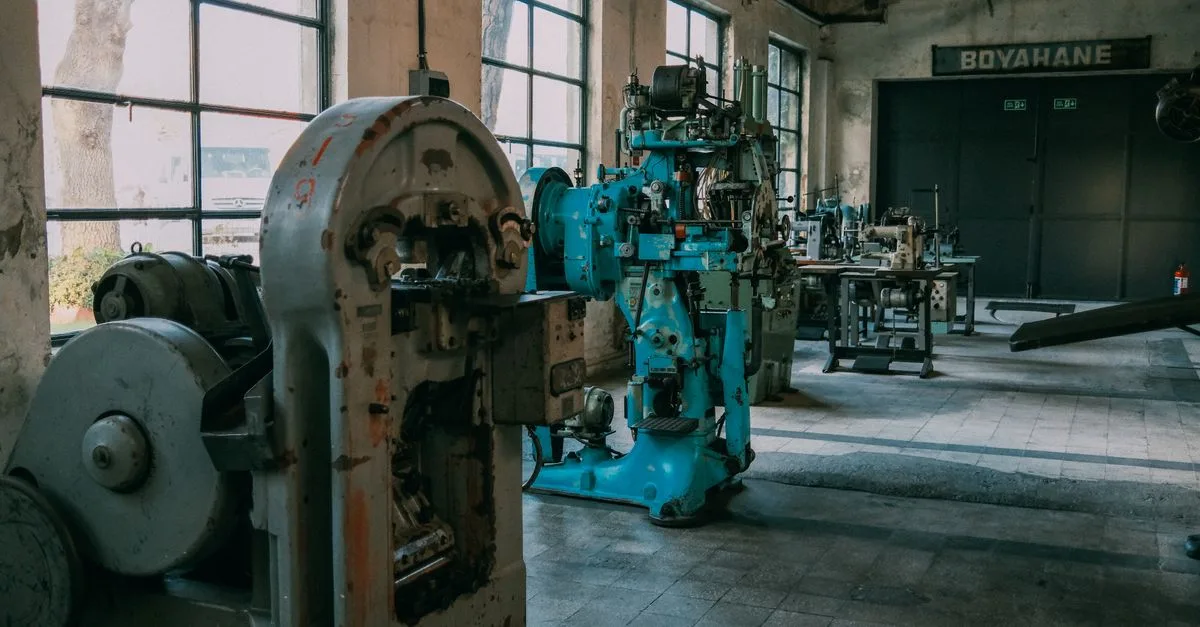 Interior of an old factory showcasing vintage machines and equipment.