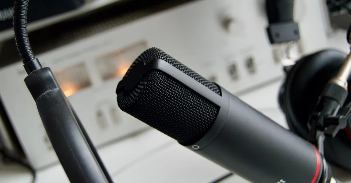 Close-up shot of a microphone in a studio setting, ideal for audio recording.