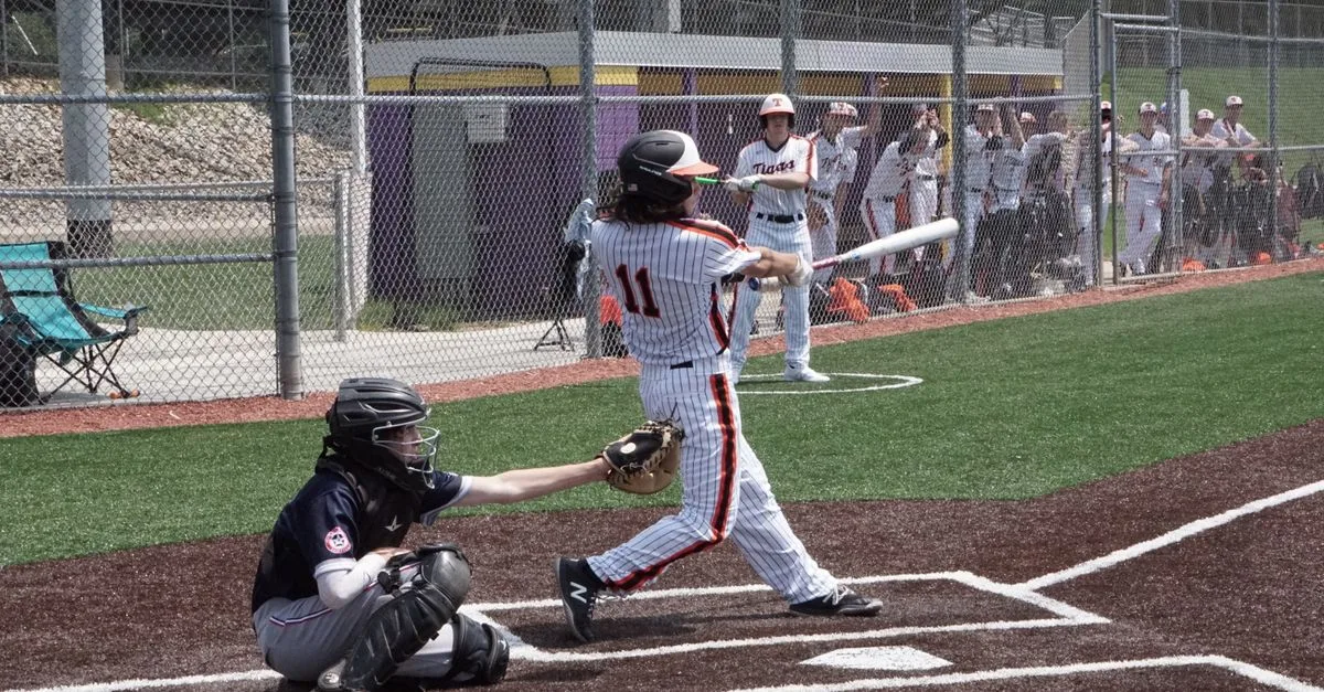 Action-packed baseball game with a player hitting the ball on a sunny day.
