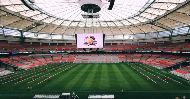 Interior view of BC Place Stadium in Vancouver, showcasing its vast seating and advanced roof structure.