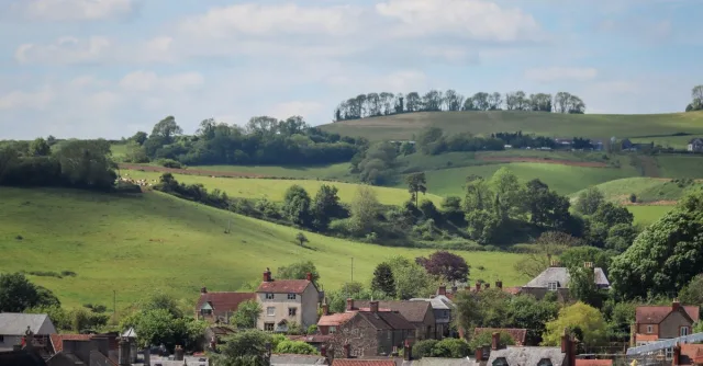 Scenic view of the countryside in Burton, England with rolling hills and picturesque houses.