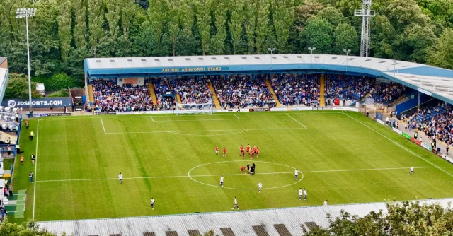 An aerial view of a football match in progress at Bury's Arthur Ashworth Stand.