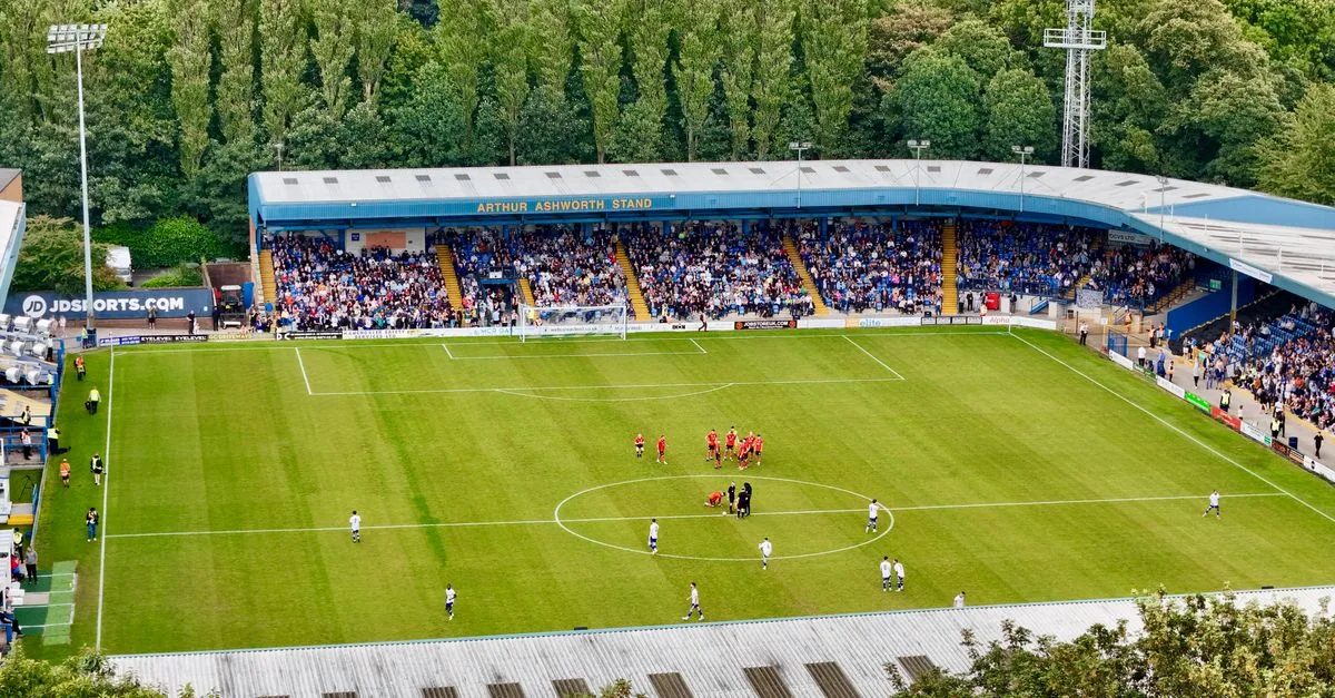 An aerial view of a football match in progress at Bury's Arthur Ashworth Stand.