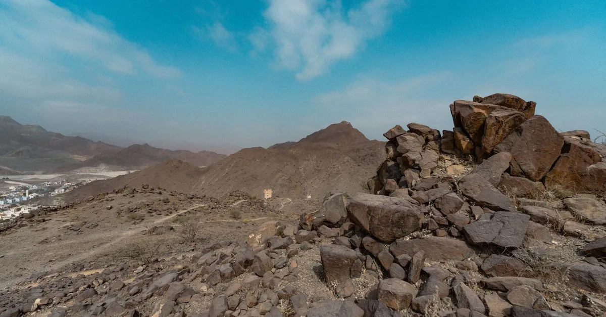 Explore the rugged landscape of Khor Fakkan, Sharjah with its dramatic rocky terrain and clear blue skies.