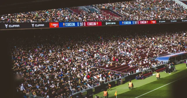 Packed stadium with spectators at an FC Barcelona soccer match, vibrant atmosphere.