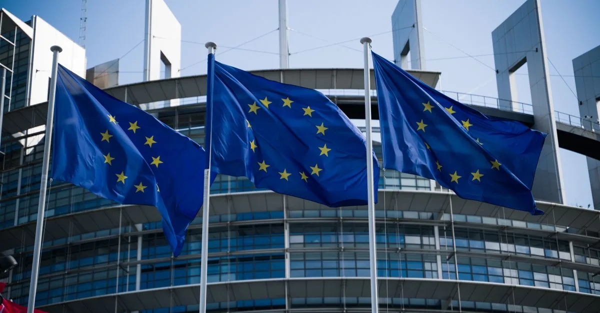 European Union flags waving outside the European Parliament in Strasbourg.
