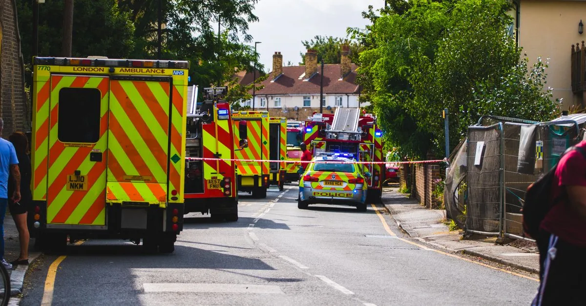 Emergency vehicles respond to an incident on a residential street, road closed.