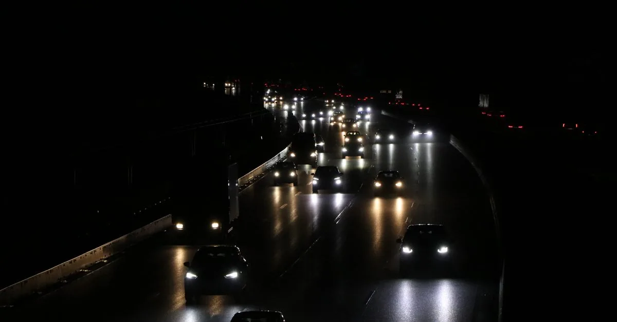 Cars and trucks drive under the night sky on a highway in Germany. Captured with a Canon EOS 80D.