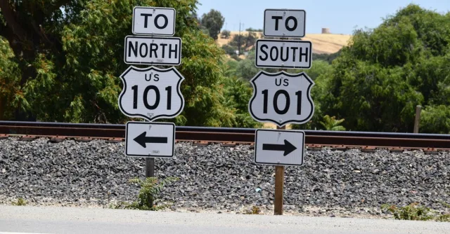 Directional signs for US Route 101 seen in San Miguel, California during a sunny day.