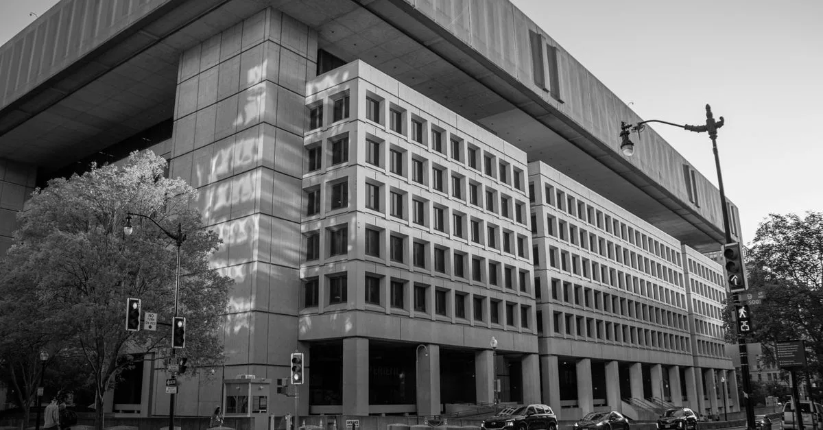 Black and white image of the FBI Headquarters in Washington, D.C. under a clear sky.