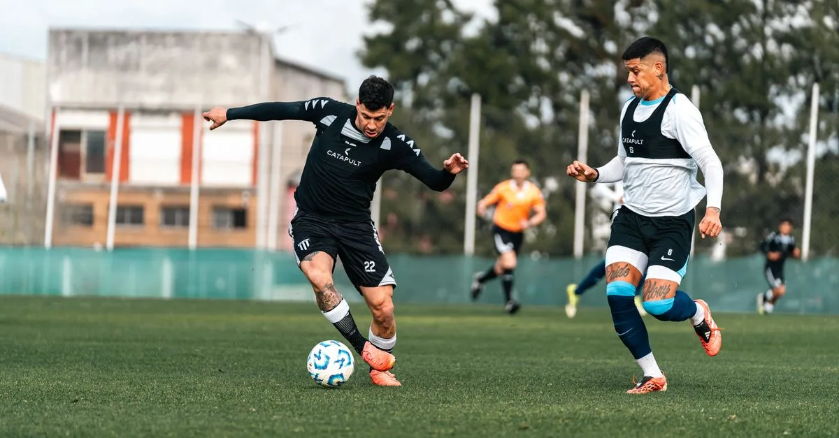 Two soccer players in mid-action during a competitive training session outdoors.