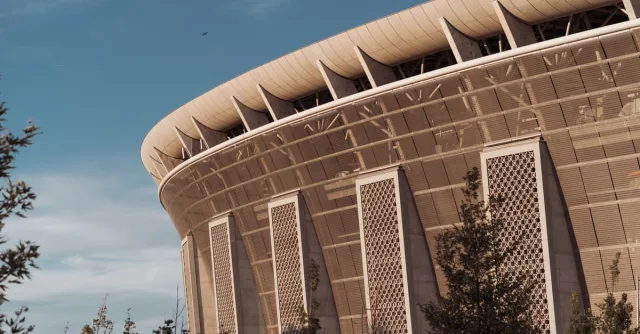 A close-up of Ferenc Puskás Stadium's architecture in Budapest, captured on a sunny day.