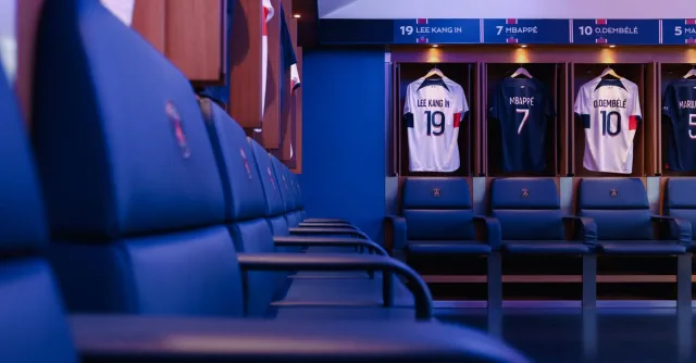 Professional football locker room in Paris with player jerseys displayed.