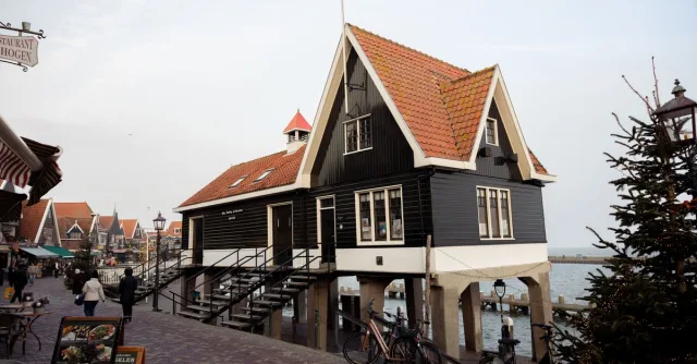 A charming stilt house by the water in Volendam, Netherlands, during daytime.