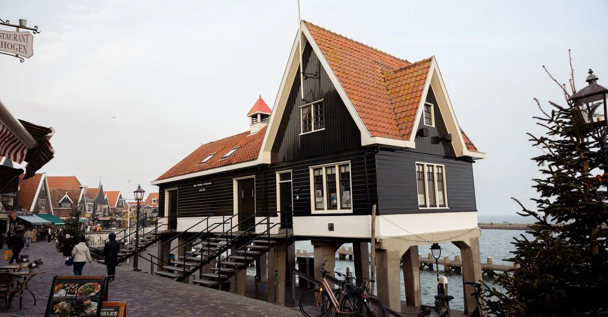 A charming stilt house by the water in Volendam, Netherlands, during daytime.